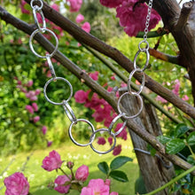 Load image into Gallery viewer, Sterling silver necklace, made up of 11 hammered silver hoops that make up the front of the necklace, that hand on a thick sterling silver chain. This necklace is 18 inches on length and has a lobster clasp to close. It comes presented in a pretty gift box making it perfect for gift giving or storing safely. Designed and Handmade in Dingle. Hallmarked in Dublin Castle