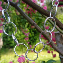 Load image into Gallery viewer, Sterling silver necklace, made up of 11 hammered silver hoops that make up the front of the necklace, that hand on a thick sterling silver chain. This necklace is 18 inches on length and has a lobster clasp to close. It comes presented in a pretty gift box making it perfect for gift giving or storing safely. Designed and Handmade in Dingle. Hallmarked in Dublin Castle