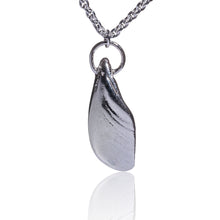 Load image into Gallery viewer, An unusual pendant made from a piece of salvaged sea shell from Castlegregory beach, and cast in sterling silver. Naturally tumbled by the ocean to create a beautifully smooth piece but still keeping its subtle markings and textures. A little piece of Kerrys Coast. This pendant is just shy of 3cm in size and sits on a chunky sterling silver chain and is 18inches in length. Hallmarked in Dublin Castle. Designed & Handmade Dingle