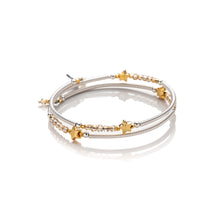 Load image into Gallery viewer, One size wrap around bangle style bracelet made from hand coiled silver filled tubes, with pretty gold plate stars, small faceted champgane coloured crystals & sterling silver beads. This bracelet has no clasp, it is flexible and simply wraps around the wrist and stays in place. It comes wrapped and presented in an eco friendly pretty linen gift pouch for safe keeping. Designed & Handmade in Dingle