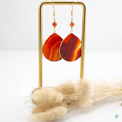 Beautiful large red carnelian teardrop statement drop earrings with small agate bead detail on gold plated stainless steel ear wires. These earrings are 5.5cm in drop length from the base of the ear wires and come with backs included. They come beautifully presented in a pretty gift box for safe keeping or making them perfect for git giving Designed and Made in Dingle