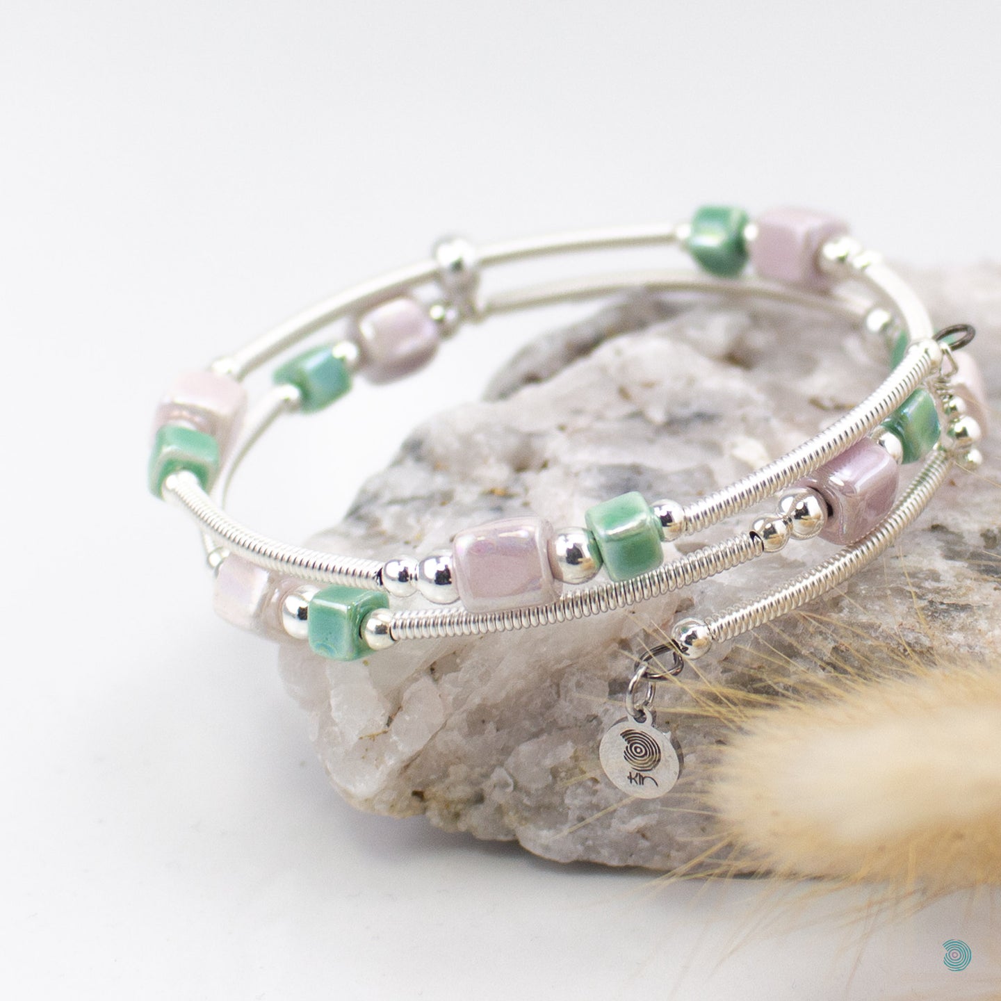 Easy to wear bracelet that simply wraps around the wrist and sits in place. No clasp needed. Hand wrapped silver filled tubes, with ceramic cubes in pale lilac and green colour mix with small sterling silver beads on each side and 