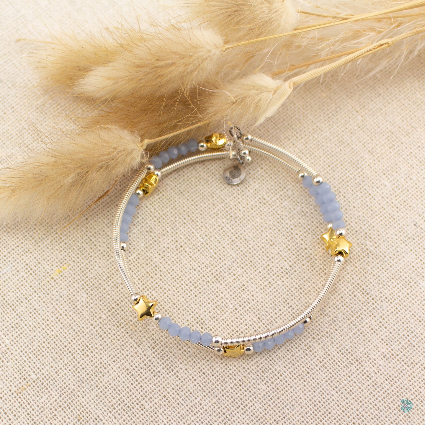 Hand wrapped silver filled tubes, blue crystal and gold plate star wrap around bracelet. Bangle style bracelet, one size flexible that wraps around the wrist and sits in place. Designed and Handmade in Dingle, Ireland.