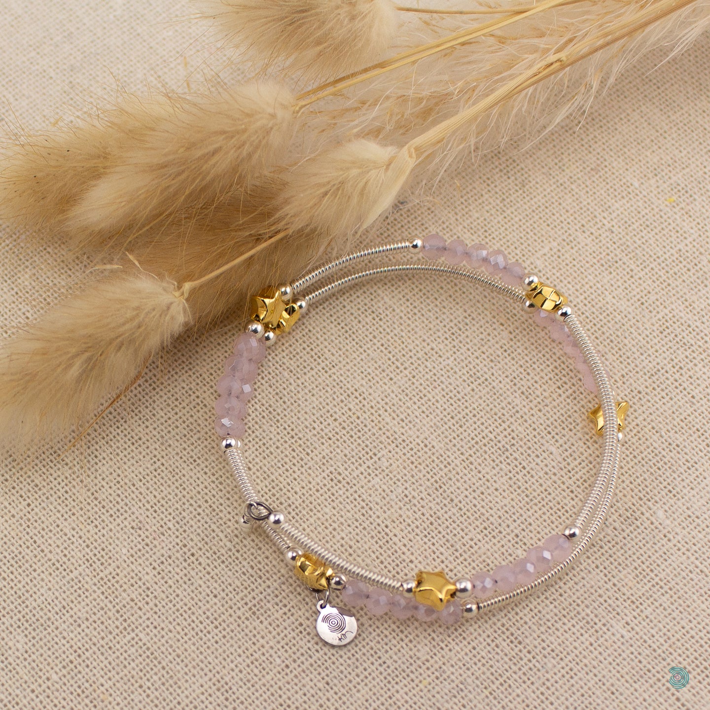 Hand wrapped silver filled tubes, with pretty pink faceted crystal beads and gold plated stars with sterling silver small bead detail. This bracelet is approximately 6 cm in diameter and simple wraps around the wrist to sit in place without the need of a clasp. It comes presented in a pretty gift pouch for safe keeping, or making it perfect for gift giving. Designed and Handmade in Dingle