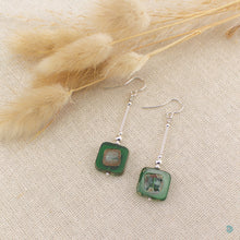 Load image into Gallery viewer, Hand wrapped silver filled drop earrings with pretty dark green Czech glass squares. These earrings sit on sterling silver ear wires and come with backs included. They are approximately 4cm in drop length from the base of the ear wires and are presented in a pretty gift pouch for safe keeping. Designed and handmade in Dingle
