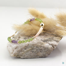 Load image into Gallery viewer, Natural Tusk Shell Bracelet with pretty faceted green peridot and amethyst stones and 14k gold filled detail. This bracelet is 7in in length and has a 1 inch extension chain for adjustment. It comes presented in a pretty gift box for safe keeping or making it perfect for gift giving. Designed and Handmade in Dingle, Ireland
