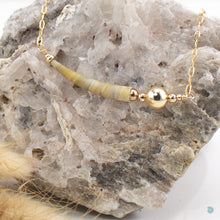 Load image into Gallery viewer, Beautiful single natural tusk shell, is gorgeous soft earthy colours with 14k gold filled bead detail. This necklace sits on a 14k gold filled chain and is 16in in length and comes with a 2 inch extension chain for adjustment. It comes presented in a branded gift box for safe keeping. Designed and Handmade in Dingle
