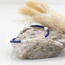 Load image into Gallery viewer, Natural tusk shell bracelet with faceted blue lapis jade stones, fresh water pearls and sterling silver. This bracelet is made using local tusk shells from my local beaches and combined with semi precious stones to create a unique piece of Irish jewellery. It is 8 inches in length and comes presented in a pretty eco friendly gift box for safe keeping. Designed and Handmade in Dingle
