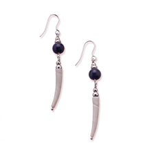 Load image into Gallery viewer, Simple drop earrings using natural Irish tusk shells in a soft off white colour.  A sodalite stone sits above the shell with a small silver disc and bead on top.  These earrings are approximately 5cm in drop length from the base of the ear wire.  They are lightweight with backs included. They come beautifully presented in an eco friendly branded gift box for safe keeping.  Designed and Handmade in Dingle.  Due to the nature of the materials used, each pair will differ slightly from the image shown
