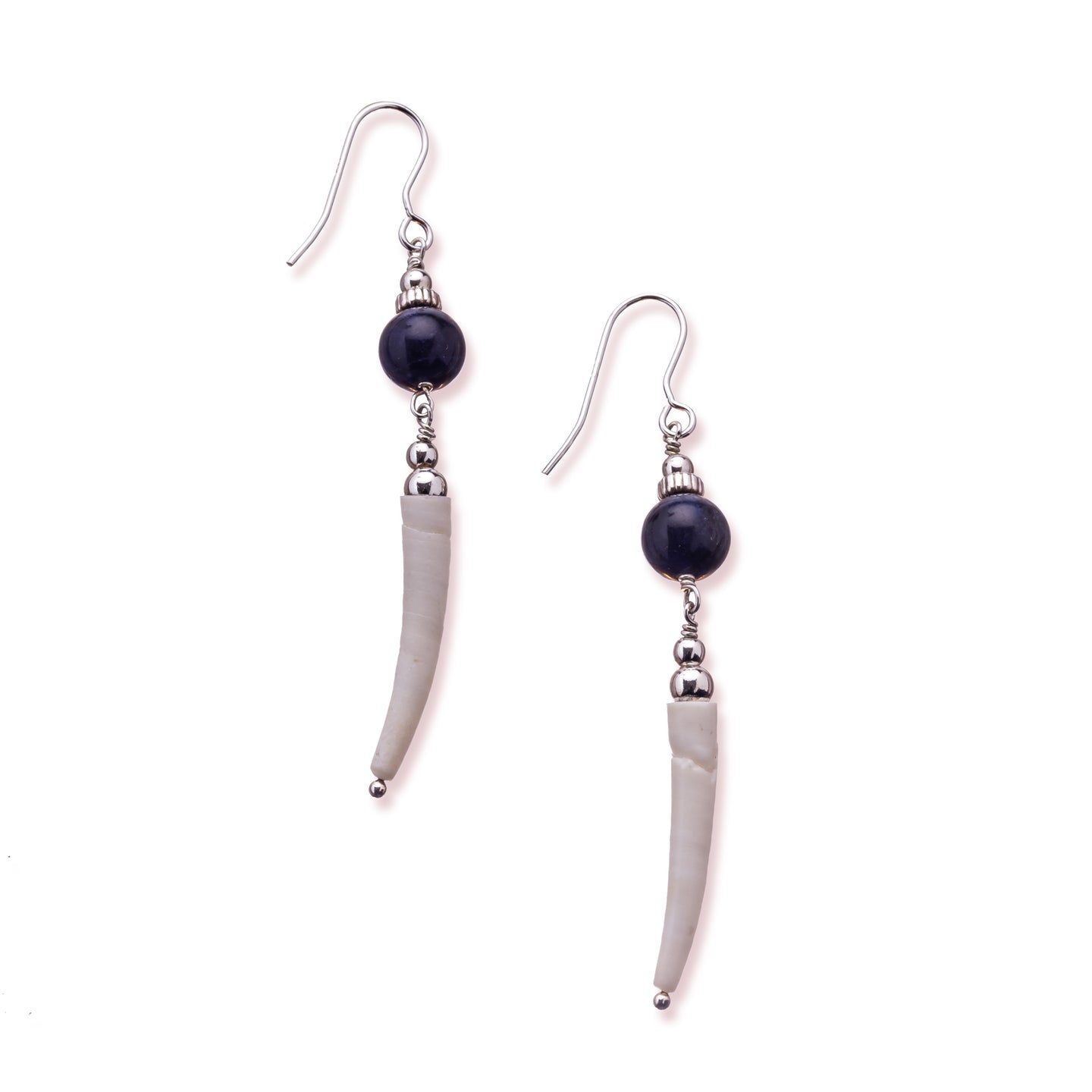 Simple drop earrings using natural Irish tusk shells in a soft off white colour.  A sodalite stone sits above the shell with a small silver disc and bead on top.  These earrings are approximately 5cm in drop length from the base of the ear wire.  They are lightweight with backs included. They come beautifully presented in an eco friendly branded gift box for safe keeping.  Designed and Handmade in Dingle.  Due to the nature of the materials used, each pair will differ slightly from the image shown