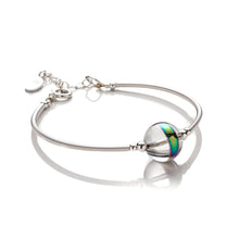 Load image into Gallery viewer, Bangle style bracelet made with hand coiled silver filled tubes and sterling silver beads.  It features a large statement crystal orb centre bead in the centre that catches the light beautifully. This bracelet measures 6cm in diameter and is semi flexible. It has a bolt ring clasp to close and an extension chain of approximately 1 inch in length. It comes beautifully presented in an eco friendly linen gift pouch for safe keeping.  Designed &amp; Handmade in Dingle
