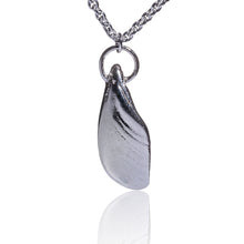 Load image into Gallery viewer, An unusual pendant made from a piece of salvaged sea shell from Castlegregory beach, and cast in sterling silver. Naturally tumbled by the ocean to create a beautifully smooth piece but still keeping its subtle markings and textures.   A little piece of Kerrys Coast.  This pendant is just shy of 3cm in size  and sits on a chunky sterling silver chain and is 18inches in length.  Hallmarked in Dublin Castle.  Designed &amp; Handmade Dingle
