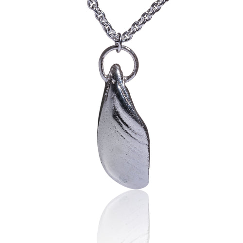 An unusual pendant made from a piece of salvaged sea shell from Castlegregory beach, and cast in sterling silver. Naturally tumbled by the ocean to create a beautifully smooth piece but still keeping its subtle markings and textures.   A little piece of Kerrys Coast.  This pendant is just shy of 3cm in size  and sits on a chunky sterling silver chain and is 18inches in length.  Hallmarked in Dublin Castle.  Designed & Handmade Dingle