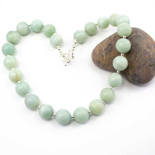 Large Statement Amazonite and Sterling Silver Beaded Necklace. 14mm Large stones separated by small sterling silver beads and finished with a twisted sterling silver T bar clasp to close. This pieces comes beautifully presented in an eco friendly branded gift box for safe keeping. Designed and Handmade in Dingle, Ireland