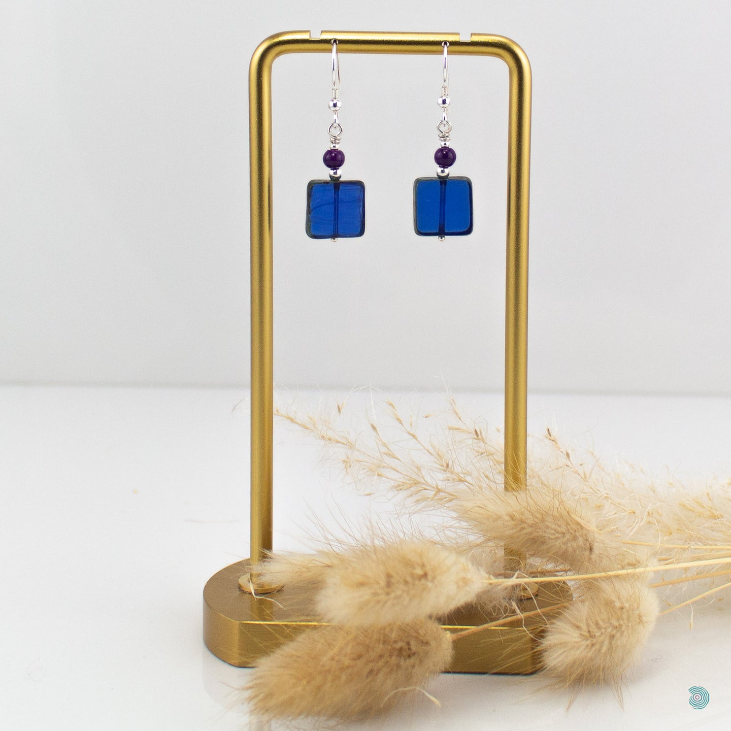 Beautiful blue Czech glass squares with small purple glass round beads and sterling silver detail.  These earrings are 2.5cm in drop length from the base of the ear wires and come with backs included.  Designed and Handmade in Dingle
