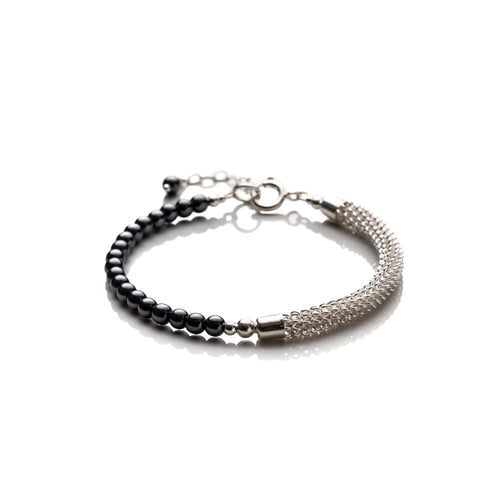 An original signature piece made using a hand wrapped silver filled tube that makes up one half of the bracelet with a row of small hematite stones on the other. This bracelet measures 6cm in diameter and is semi flexible, it has a bolt ring clasp and an extension chain of approximately 1 inch. It comes beautifully presented in an eco friendly linen gift pouch for safe keeping. Designed and Handmade in Dingle