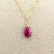Load image into Gallery viewer, Beautiful, simple style, faceted ruby red teardrop pendant, wrapped in a 14k gold filled nest that sits on a gold filled chain. 18inches in length with a 2 inch extension chain for adjustment. Designed and Handmade in Dingle. If you would like your jewellery gift wrapped and a message added please add a little note in with your order and I will happily wrap it for you!
