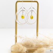 Load image into Gallery viewer, A real summer statement pair of earrings  Hand wrapped silver filled large double hoops with vibrant yellow Czech glass square centre beads.  These earrings are are lightweight and approximately 5cm in drop length from the base of sterling silver ear wires, they come with backs included.  They are presented in a pretty gift box for safe keeping or making them perfect for gift giving  Designed and Handmade in Dingle
