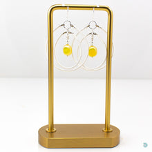 Load image into Gallery viewer, A real summer statement pair of earrings  Hand wrapped silver filled double hoops with vibrant yellow Czech glass square centre beads and sterling silver bead detail.  These earrings are are lightweight and approximately 5cm in drop length from the base of sterling silver ear wires, they come with backs included. Designed and Handmade in Dingle
