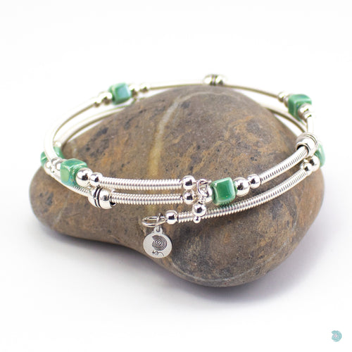 Hand wrapped silver filled wrap around bracelet, green ceramic cubes and silver bead detail. Approximate diameter is 6cm and is flexible to fit most wrist sizes. This bracelet has no clasp is simply wraps around the wrist and sits in place. Designed and Handmade in Dingle, Ireland. KellyMarie Jewellery Design