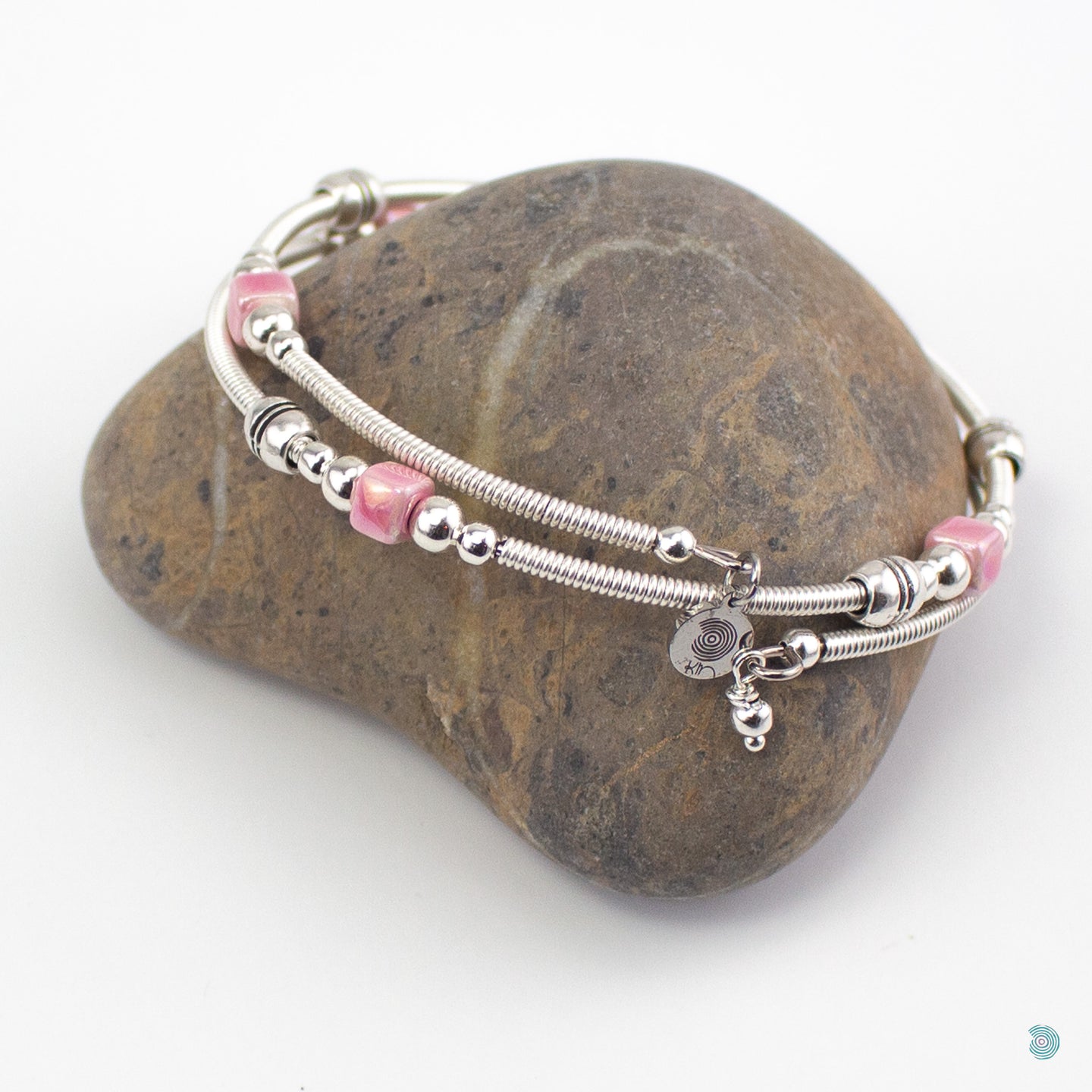 Hand wrapped silver filled wrap around bracelet, pink ceramic cubes and silver bead detail. Approximate diameter is 6cm and is flexible to fit most wrist sizes. This bracelet has no clasp is simply wraps around the wrist and sits in place. Designed and Handmade in Dingle, Ireland. KellyMarie Jewellery Design