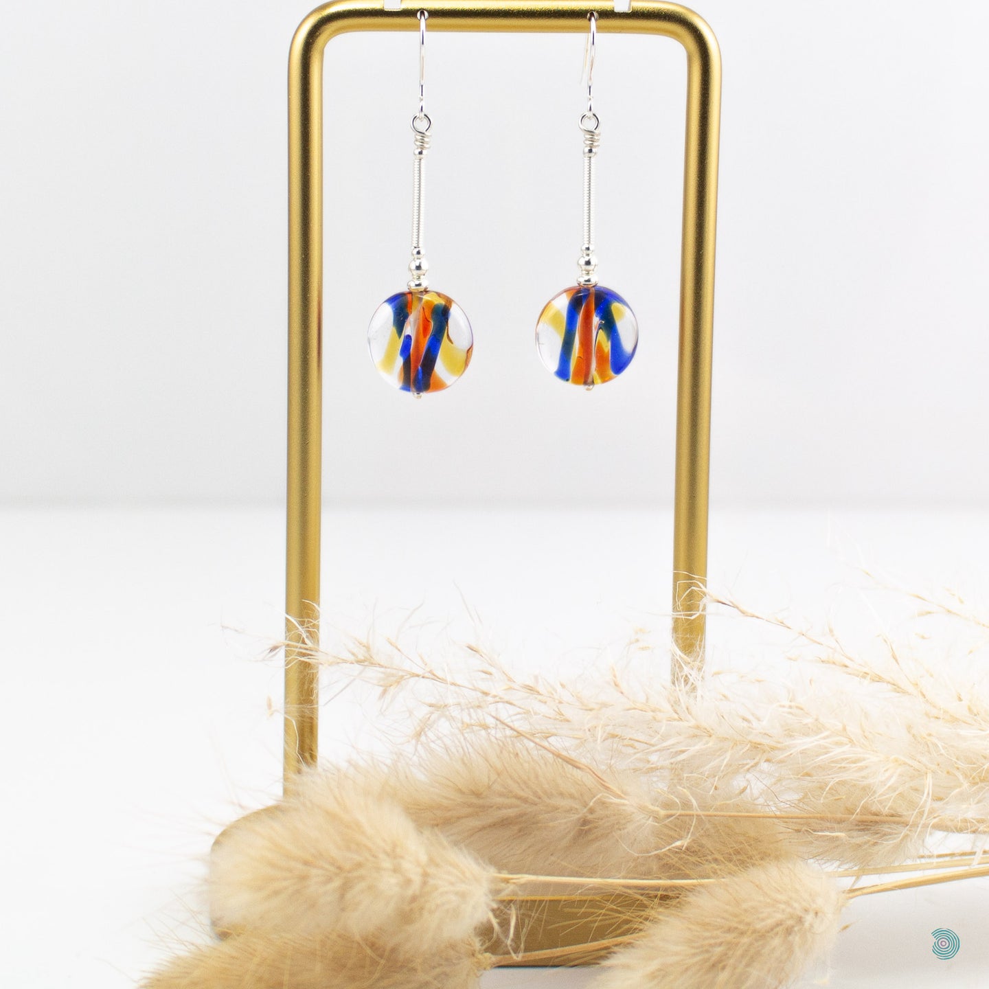 Colourful summer drop earrings, with hand wrapped silver filled tubes, sterling silver bead and ear wire detail with beautiful lamp work glass beads in a mix of reds/blues and yellows.  These earrings are 3.5cm in drop length from the base of the ear wires and come with backs included.  They come presented in a pretty gift box for safe keeping or making them perfect for gift giving  Designed and Handmade in Dingle 