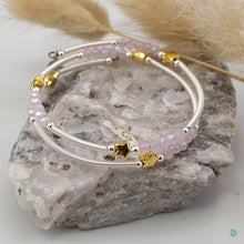 Load image into Gallery viewer, Hand wrapped silver filled tubes, with pretty pink faceted crystal beads and gold plated stars with sterling silver small bead detail.  This bracelet is approximately 6 cm in diameter and simple wraps around the wrist to sit in place without the need of a clasp. Designed and Handmade in Dingle  If you would like your jewellery gift wrapped and a message added please add a little note in with your order and I will happily wrap it for you!  
