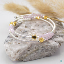 Load image into Gallery viewer, Hand wrapped silver filled tubes, with pretty pink faceted crystal beads and gold plated stars with sterling silver small bead detail.  This bracelet is approximately 6 cm in diameter and simple wraps around the wrist to sit in place without the need of a clasp. It comes presented in a pretty gift pouch for safe keeping, or making it perfect for gift giving.  Designed and Handmade in Dingle 
