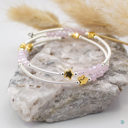 Hand wrapped silver filled tubes, with pretty pink faceted crystal beads and gold plated stars with sterling silver small bead detail.  This bracelet is approximately 6 cm in diameter and simple wraps around the wrist to sit in place without the need of a clasp. It comes presented in a pretty gift pouch for safe keeping, or making it perfect for gift giving.  Designed and Handmade in Dingle 