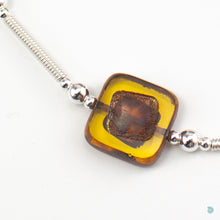 Load image into Gallery viewer, Close up of Amber coloured Czech glass square beads and silver bead and tube detail

