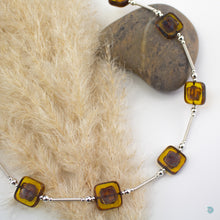 Load image into Gallery viewer, Hand wrapped silver filled tubes, with amber coloured Czech glass squares and sterling silver beads.  This necklace is 18 inches in length and has a 2 inch extension chain for adjustment.  It comes in a branded gift box for safe keeping or making it perfect for gift giving.  Designed and Handmade in Dingle 
