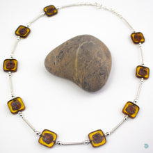 Load image into Gallery viewer, Hand wrapped silver filled tubes, with amber coloured Czech glass squares and sterling silver beads.  This necklace is 18 inches in length and has a 2 inch extension chain for adjustment.  It comes in a branded gift box for safe keeping or making it perfect for gift giving.  Designed and Handmade in Dingle  If you would like your jewellery gift wrapped and a message added please add a little note in with your order and I will happily wrap it for you
