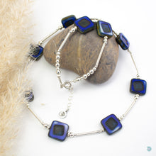 Load image into Gallery viewer, Hand wrapped silver filled tubes, with vibrant blue coloured Czech glass squares and sterling silver beads.  This necklace is 18 inches in length and has a 2 inch extension chain for adjustment.  It comes in a branded gift box for safe keeping or making it perfect for gift giving.  Designed and Handmade in Dingle  If you would like your jewellery gift wrapped and a message added please add a little note in with your order and I will happily wrap it for you
