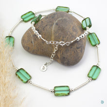 Load image into Gallery viewer, Hand wrapped silver filled tubes, with pretty green coloured Czech glass and sterling silver beads.  This necklace is 18 inches in length and has a 2 inch extension chain for adjustment.  It comes in a branded gift box for safe keeping or making it perfect for gift giving.  Designed and Handmade in Dingle  If you would like your jewellery gift wrapped and a message added please add a little note in with your order and I will happily wrap it for you
