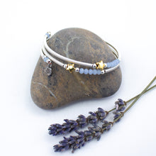 Load image into Gallery viewer, Hand wrapped silver filled tubes, blue crystal and gold plate star wrap around bracelet.  Bangle style bracelet, one size flexible that wraps around the wrist and sits in place.  Designed and Handmade in Dingle, Ireland.  
