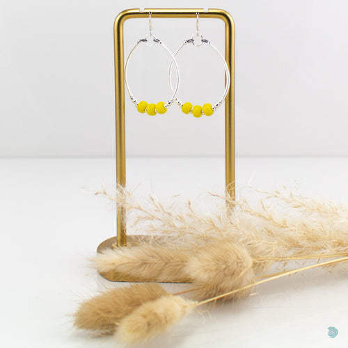 Hand wrapped silver filled hoops with bright yellow glass beads and sterling silver bead detail.  These earrings are 4.5cm in drop length from the base of the ear wires and come with backs included.  They come presented in a pretty gift pouch for safe keeping or making them perfect for gift giving