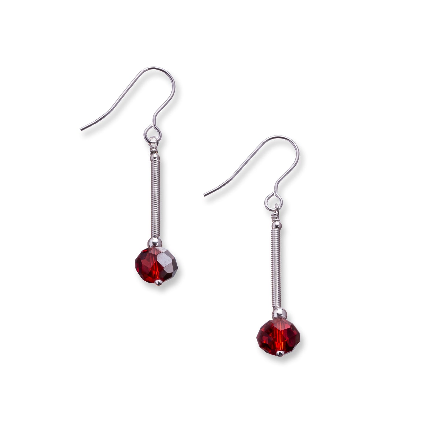 Crystal drops made from hand coiled silver filled tubes, sterling silver beads and faceted crystals in a choice of three colours, rich red, deep teal blue and soft llight pink.These earrings sit on sterling silver ear wires and come with backs included. The drop length 3cm and is measured from the base of the ear wire. They are lightweight and come beautifully presented in an eco friendly branded gift box for safe keeping. Designed & Handmade in Dingle