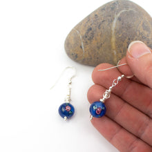 Load image into Gallery viewer, Short and Sweet Earrings with navy blue floral lampwork glass beads and handwrapped silver filled scribble beads. Sterling silver ear wires that come with backs. They are 2.5cm in drop length from the base of the earwires and come in a pretty gift pouch for safe keeping. Designed and Handmade in Dingle
