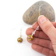 Load image into Gallery viewer, Short and Sweet Earrings with mustard yellow floral lampwork glass beads and handwrapped silver filled scribble beads. Sterling silver ear wires that come with backs. They are 2.5cm in drop length from the base of the earwires and come in a pretty gift pouch for safe keeping. Designed and Handmade in Dingle
