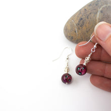 Load image into Gallery viewer, Short and Sweet Earrings with plum coloured floral lampwork glass beads and handwrapped silver filled scribble beads. Sterling silver ear wires that come with backs. They are 2.5cm in drop length from the base of the earwires and come in a pretty gift pouch for safe keeping. Designed and Handmade in Dingle
