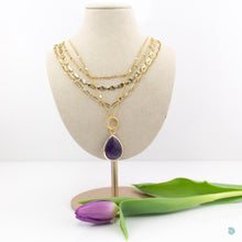 Load image into Gallery viewer, Large Amethyst teardrop pendant, sitting on a small chunky gold plated hoop, suspended on a gold plated stainless steel chain. This necklace is 20 inches in length with a 2inch extension chain. It comes presented in a pretty gift box for safe keeping or making it perfect for gift giving. Designed and made in Dingle
