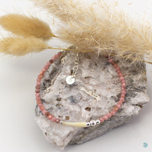 Load image into Gallery viewer, Natural tusk shell bracelet with beautiful rhodochrosite stones, combined with sterling silver bead detail. This piece is approximately 7 inches in length and has a 1 inch extension chain for adjustment. It comes presented in a pretty gift box for safe keeping or making it perfect for gift giving Designed and Handmade in Dingle 
