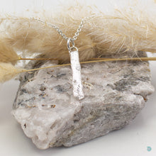 Load image into Gallery viewer, A beautiful pendant created from a small piece of driftwood I discovered bathing in the sun at the side of a rockpool on Ventry beach, on the Dingle peninsula.  This pendant is cast in sterling silver and sits on a thick 18 inch sterling silver chain inch with a 2 inch extension for adjustment. It is simple and delicate and comes beautifully presented in an eco friendly branded gift box, ready to join its new owner on their ongoing journey. 
