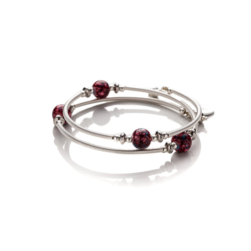 One size bangle style wrap around bracelet made with hand coiled silver filled tubes with with a mix of small sterling silver round beads, stainless steel rondelle beads and deep red spotted glass beads. This bracelet has no clasp, it is flexible and simply wraps around the wrist and stays in place. It comes beautifully presented in an eco friendly linen gift pouch for safe keeping. Designed & Handmade in Dingle