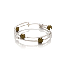 Load image into Gallery viewer, One size bangle style wrap around bracelet made from hand coiled silver filled tubes with deep olive green round glass beads &amp; sterling silver beads. This piece has silver plated rectangular beads that slide freely along the tubes. It has no clasp, it is flexible and simply wraps around the wrist and stays in place. It comes beautifully presented in an eco friendly linen gift pouch. Designed &amp; Handmade in Dingle
